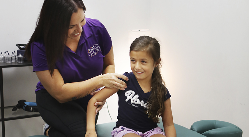 massage therapist working with child